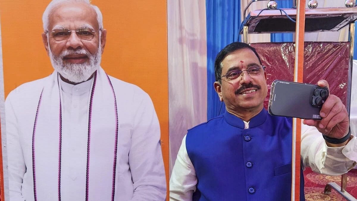 <div class="paragraphs"><p>Union Minister Pralhad Joshi takes a selfie with the cutout of Prime Minister Narendra Modi during the 'Viksit Bharat Sankalp Yatra', in Hubballi.&nbsp;</p></div>