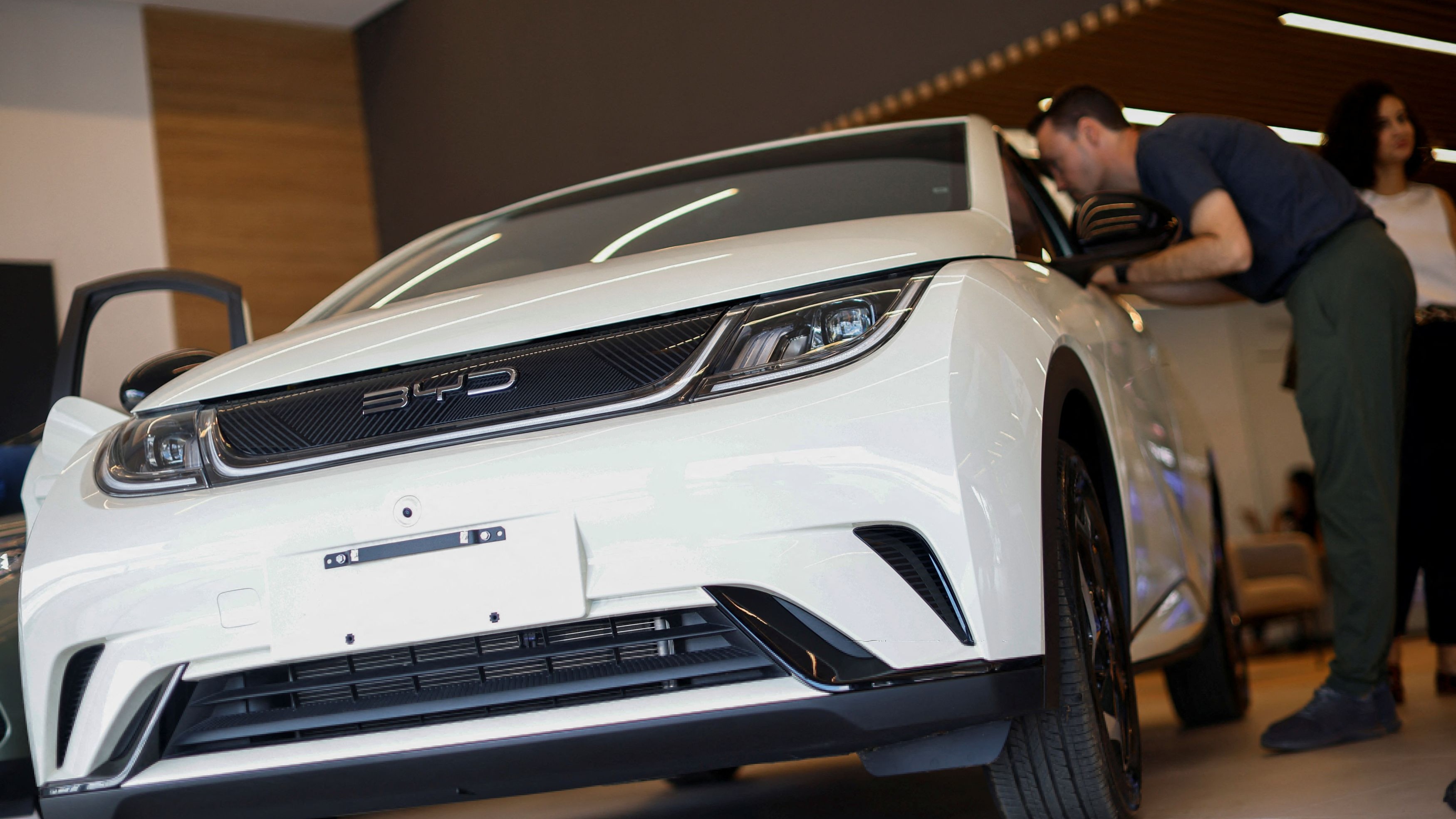 <div class="paragraphs"><p>A man looks into a BYD electric vehicle at a BYD dealership in&nbsp;Brasilia, Brazil, October 24, 2023. </p></div>