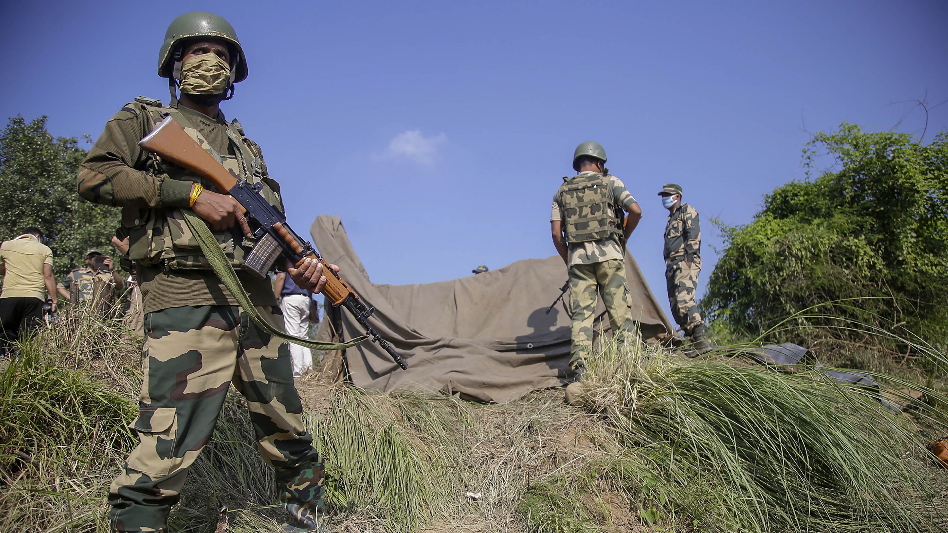 <div class="paragraphs"><p>Border Security Force (BSF) personnel stand near a tunnel, originating from Pakistan, beneath the Indo-Pak international border fence, in J&amp;K's Samba district. </p></div>