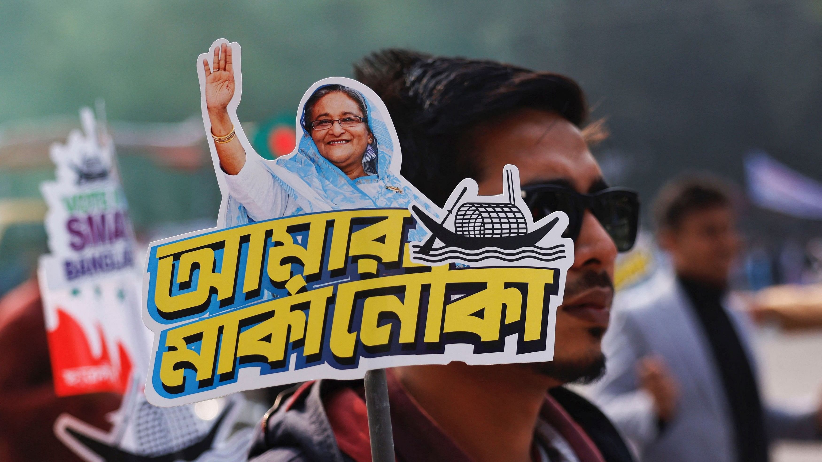 <div class="paragraphs"><p>A student holds a placard of Prime Minister Sheikh Hasina as they celebrate the formation day of Bangladesh Chhatra League, in Dhaka.&nbsp;</p></div><div class="paragraphs"><p><strong><br></strong></p></div>