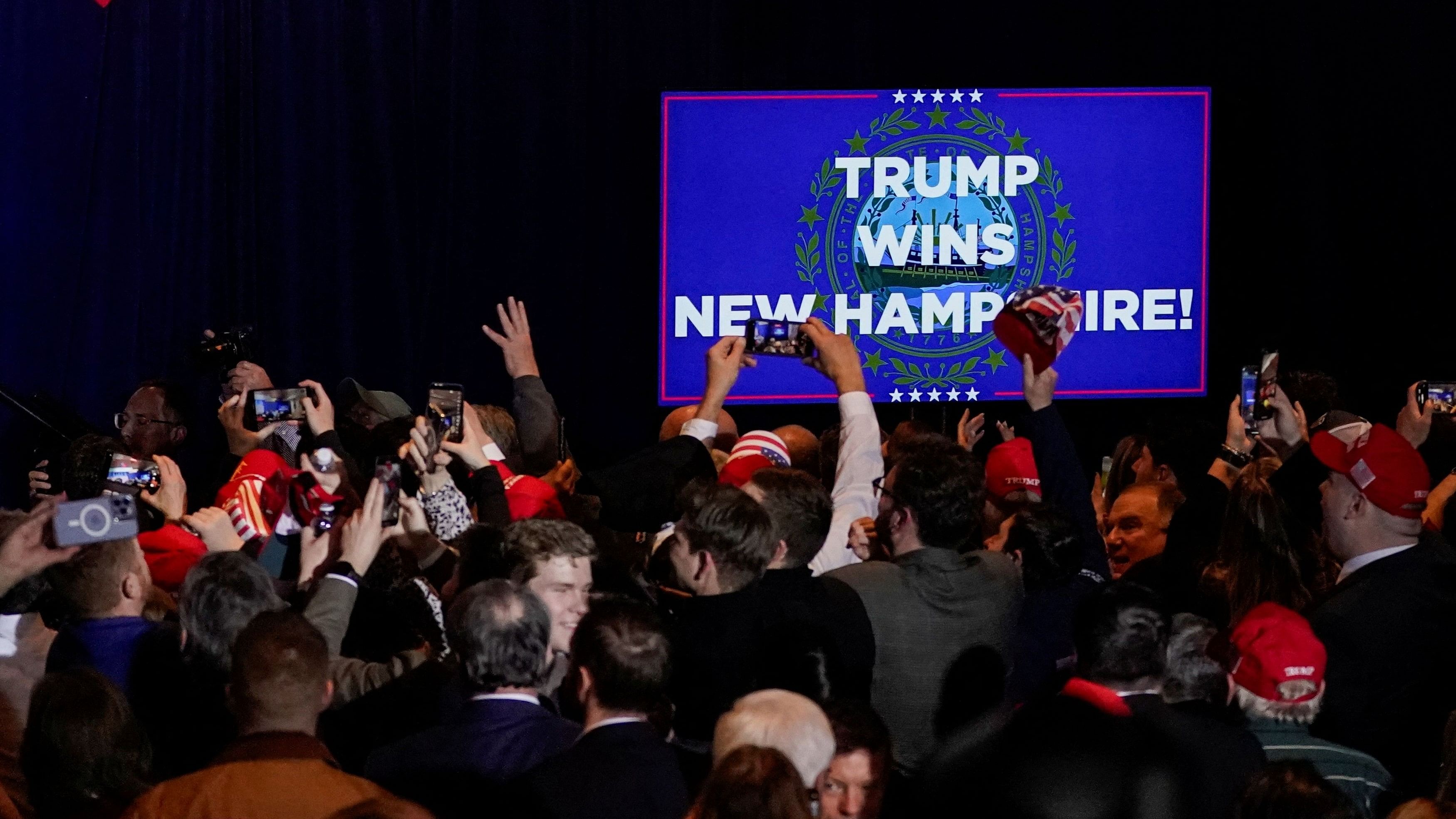 <div class="paragraphs"><p>Supporters react after major news organisations project that Republican presidential candidate and former US President Donald Trump wins, during a New Hampshire presidential primary election night watch party in Nashua, New Hampshire.</p></div>