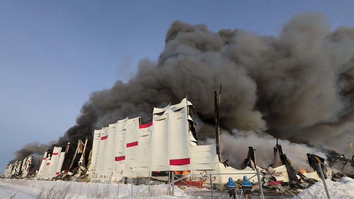 <div class="paragraphs"><p>Smoke from fire rises above the burning warehouse of Wildberries online retailer in Saint Petersburg, Russia, January 13, 2024.</p></div>