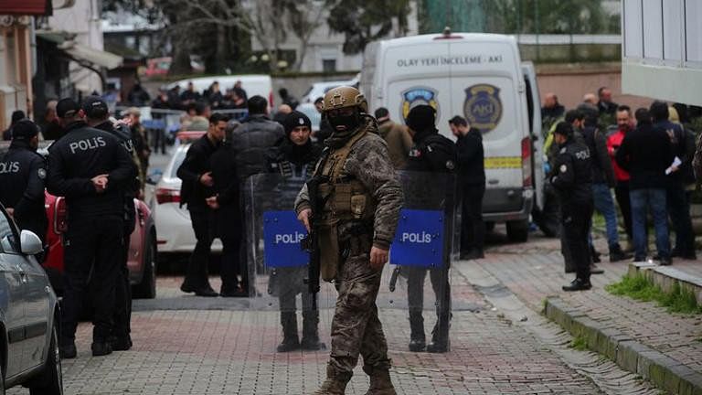 <div class="paragraphs"><p>Turkish police stand guard outside the Italian Santa Maria Catholic Church after two masked gunmen were shooting during Sunday service, in Istanbul, Turkey.</p></div>