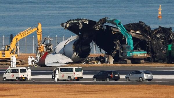 <div class="paragraphs"><p>Officials remove the wreckage of a burnt Japan Airlines (JAL) Airbus A350 plane after a collision with a Japan Coast Guard aircraft at Haneda International Airport in Tokyo, Japan January 5, 2024.</p></div>