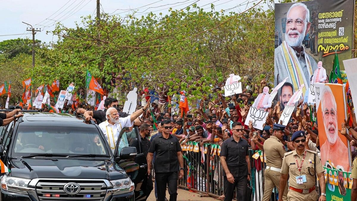 <div class="paragraphs"><p>Prime Minister Narendra Modi waves at supporters during a roadshow, in Thiruvananthapuram.</p></div>