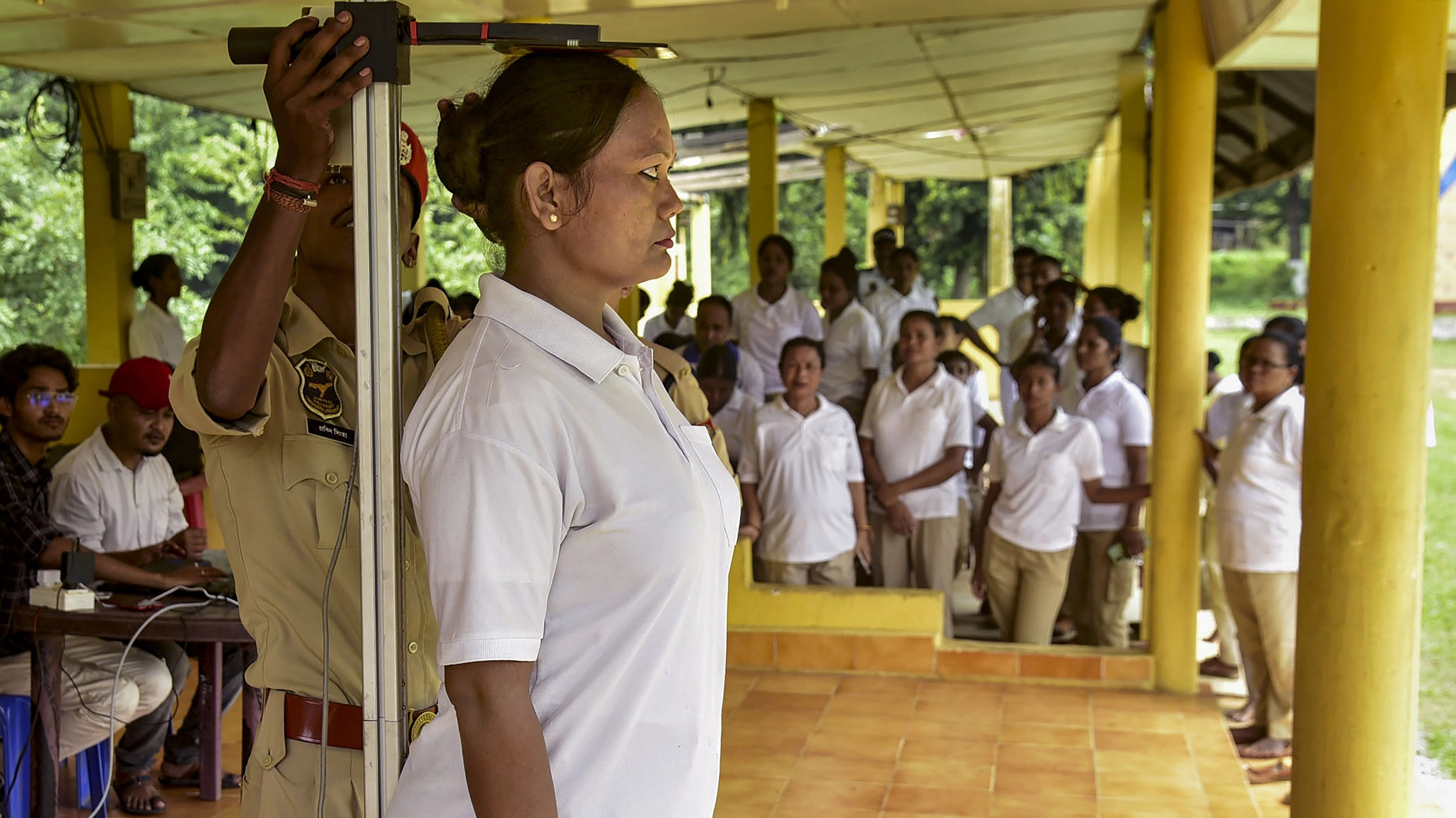 <div class="paragraphs"><p>A woman police personnel gets her height measured during a Body Mass Index (BMI) assessment for Assam Police personnel, in Guwahat.</p></div>