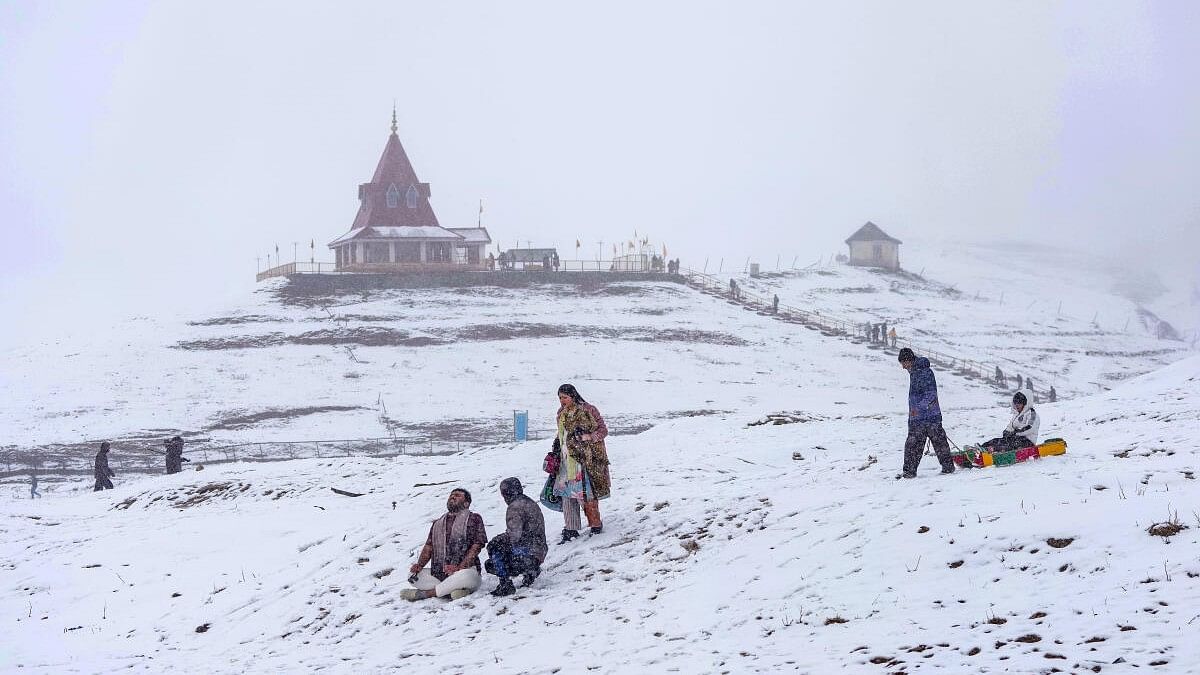 <div class="paragraphs"><p>Tourists amid light snowfall at ski resort Gulmarg, in Baramulla district.&nbsp;The place received fresh snowfall breaking a two-month-long dry spell.</p></div>