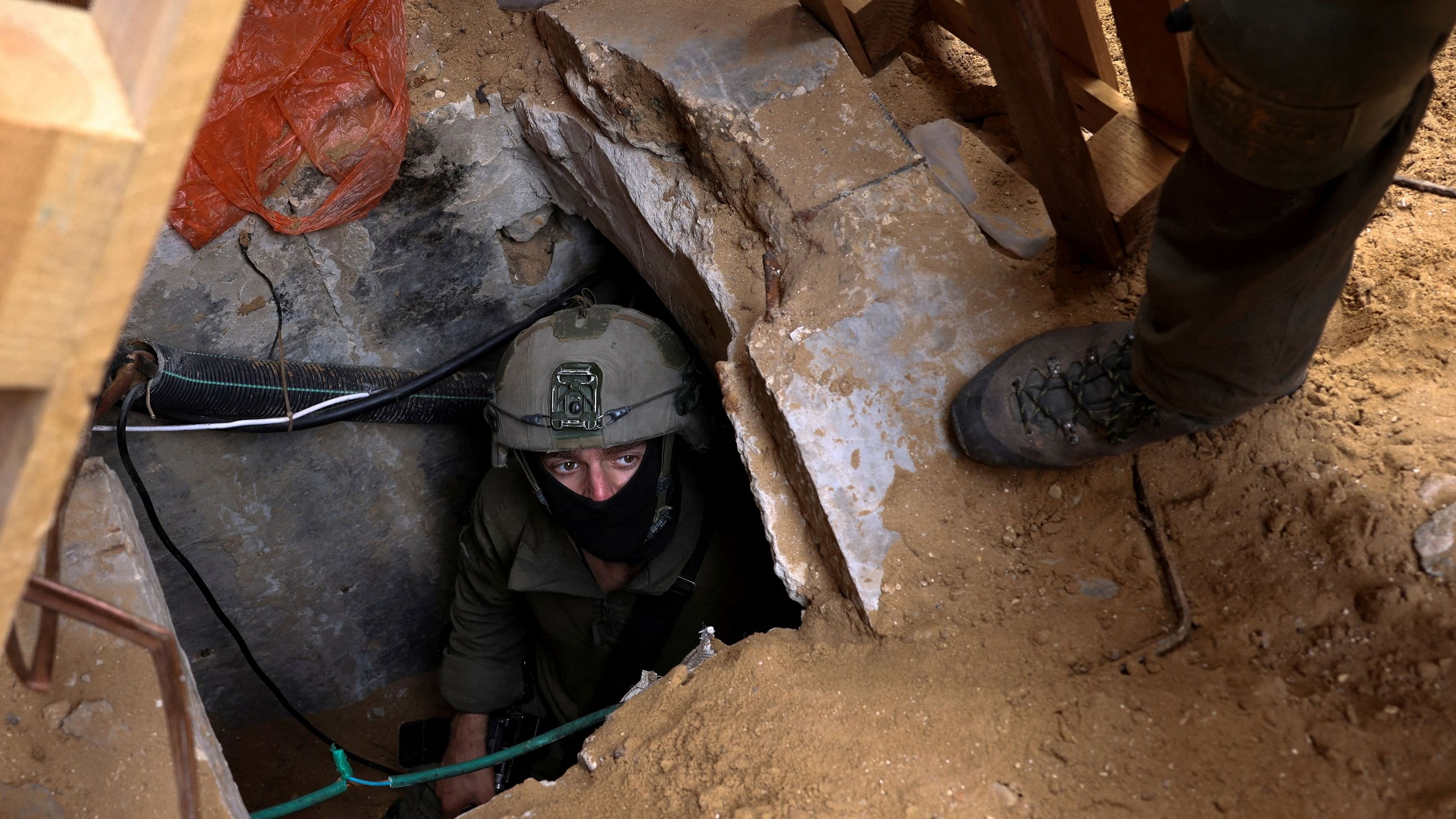 <div class="paragraphs"><p>Israeli soldiers operate at the opening to a tunnel at Al Shifa Hospital compound in Gaza City during the&nbsp;ground operation of the Israeli army against Palestinian Islamist group Hamas.</p></div>