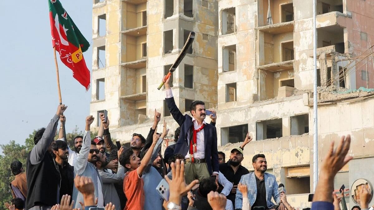 <div class="paragraphs"><p>Pakistan Tehreek-e-Insaf (PTI) and former PM Imran Khan's lawyer Sher Afzal Khan Marwat, waves a cricket bat after the Election Commission stripped the party's electoral symbol of a cricket bat on technical grounds, during a rally ahead of general elections in Karachi.</p></div>