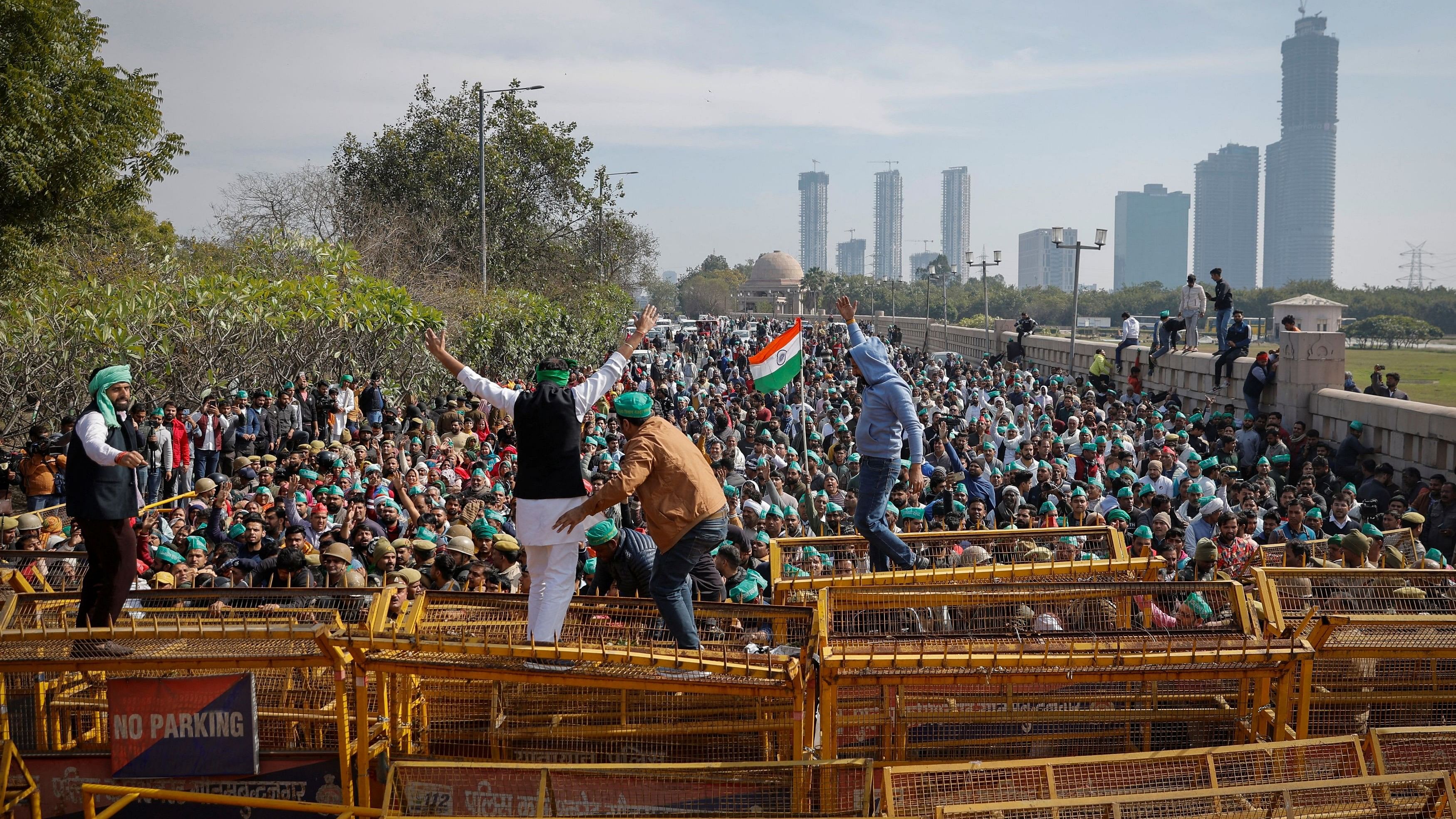 <div class="paragraphs"><p>Farmers climb a police barricade during a protest demanding a hike in land compensation and better rehabilitation facilities for their families, in Noida on the outskirts of New Delhi, India, February 8, 2024.</p></div>