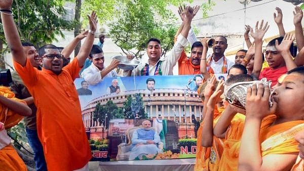 <div class="paragraphs"><p> NDA supporters pour milk over a photo of Prime Minister Narendra Modi after their victory in 2019 Lok Sabha polls.</p></div>