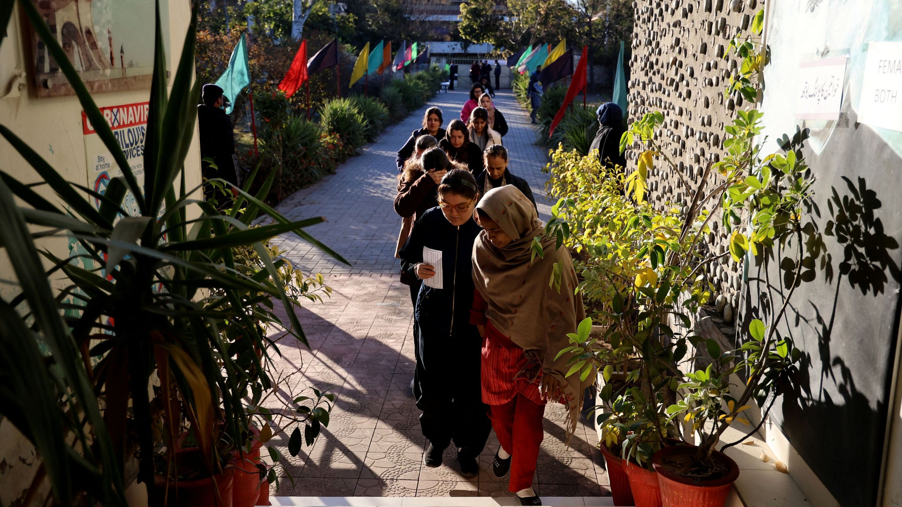 <div class="paragraphs"><p>The voters enter a polling station in a school on the day of the general election, in Islamabad, Pakistan.</p></div>