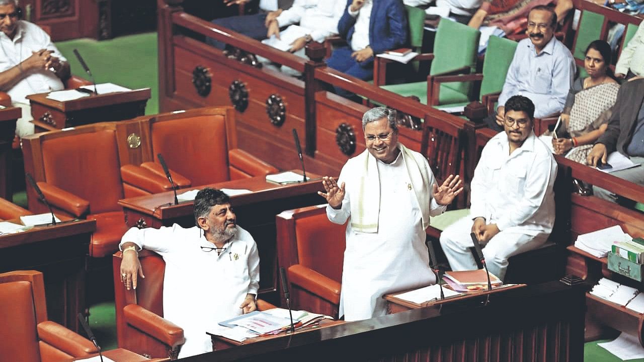 Chief Minister Siddaramaiah makes a point in the Legislative Assembly on Tuesday. Deputy Chief Minister D K Shivakumar is also seen. 