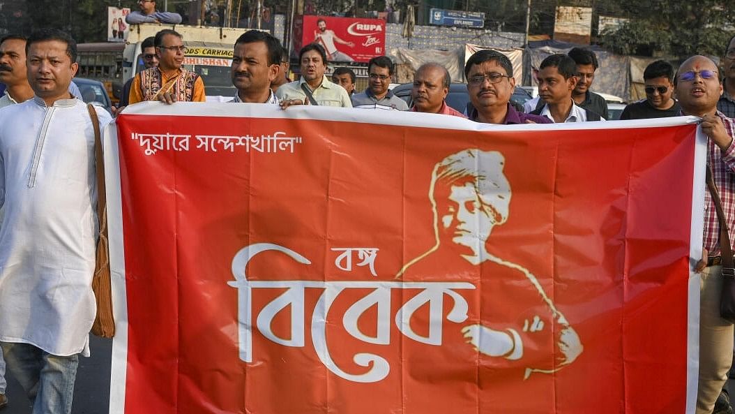 <div class="paragraphs"><p>People hold a banner during a protest march against Sandeshkhali case, in Kolkata.</p></div>