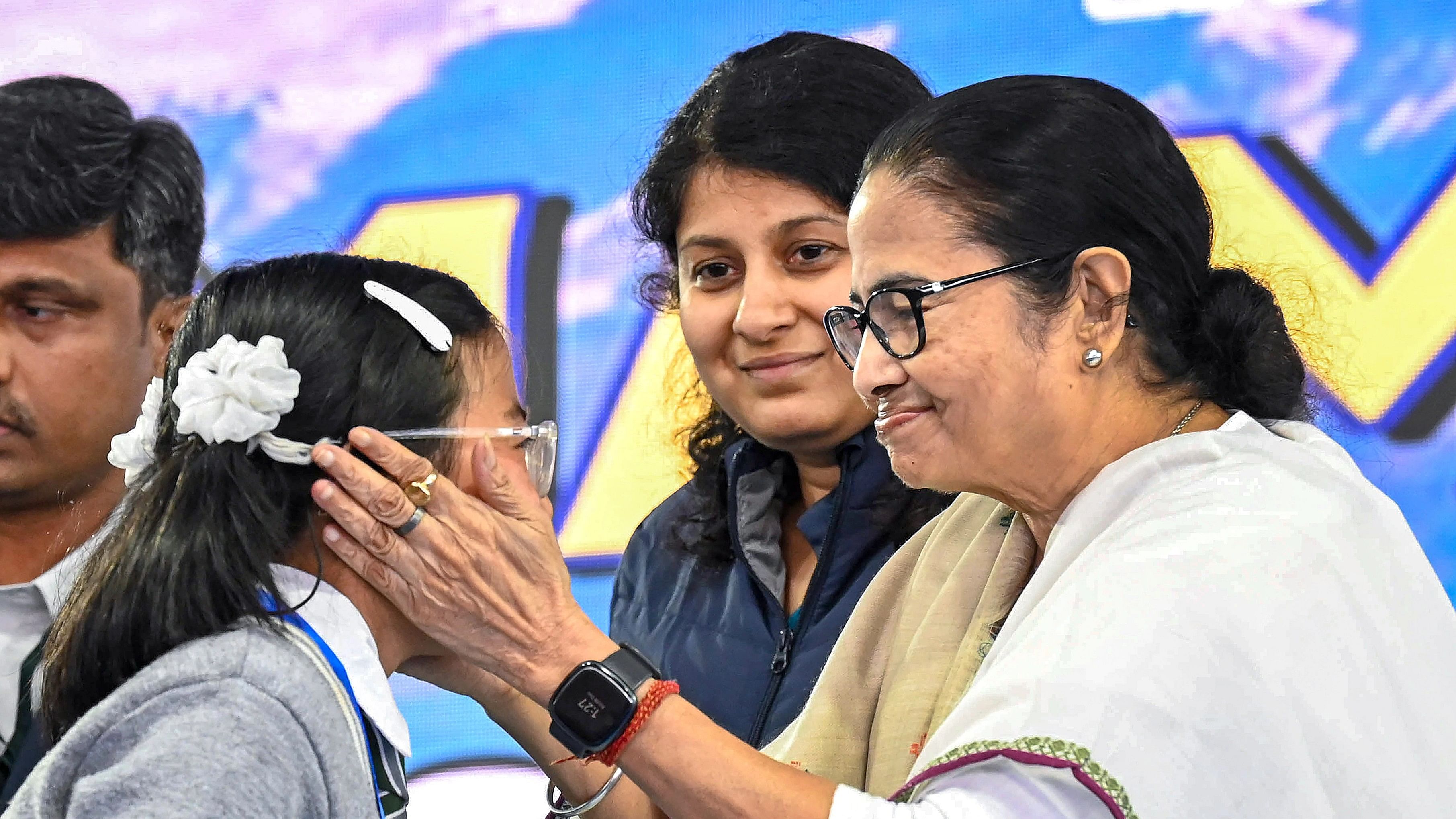 <div class="paragraphs"><p>A file photo of Mamata Banerjee with a child in West Bengal</p></div>