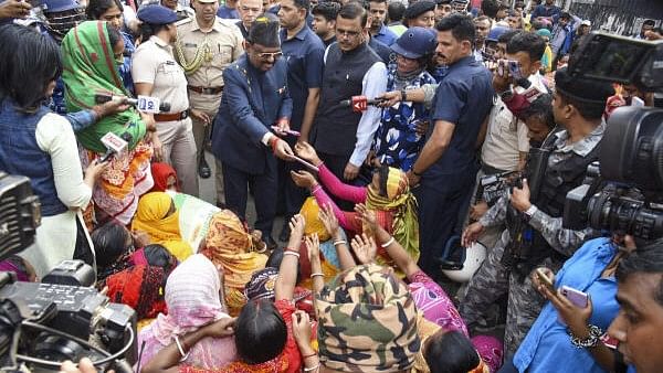 <div class="paragraphs"><p>West Bengal Governor CV Ananda Bose with women protestors and others at Sandeshkhali block, in North 24 Parganas district, Monday, February 12, 2024</p></div>