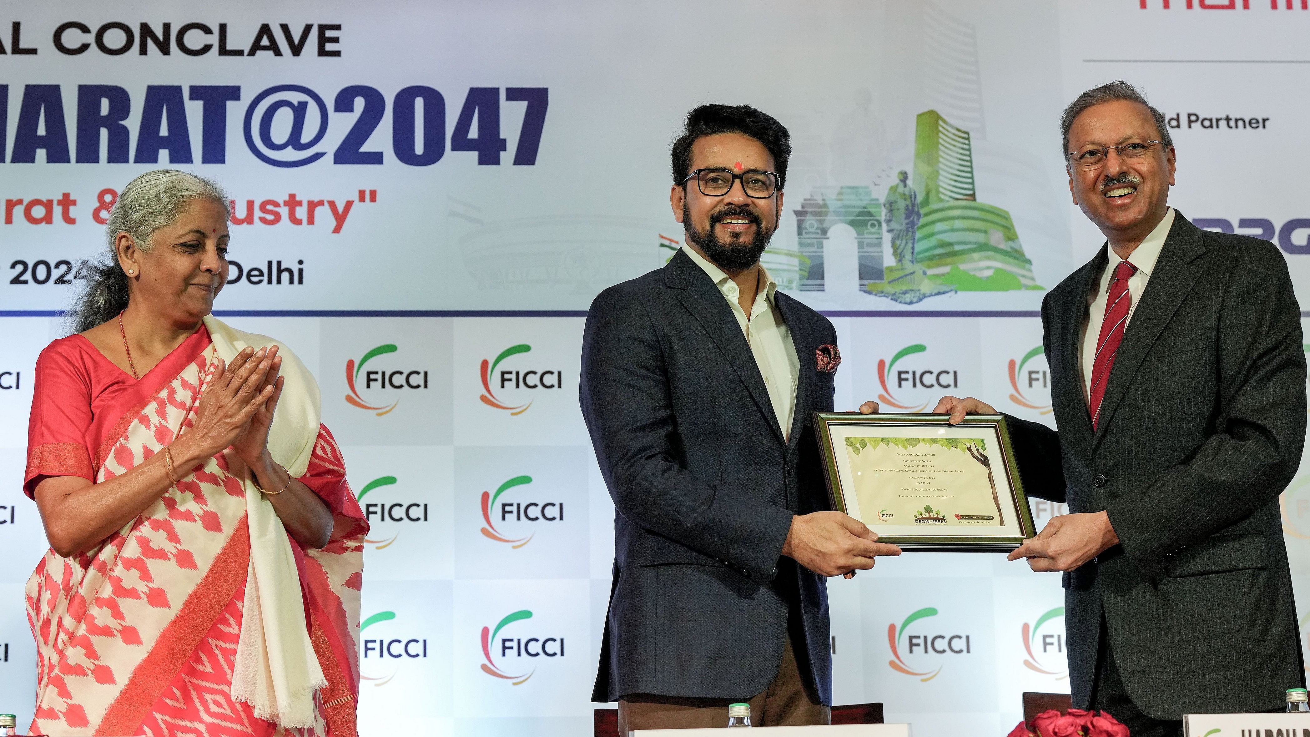 <div class="paragraphs"><p> Union I &amp; B Minister Anurag Thakur being presented a green certificate by FICCI Past President Harsh Pati Singhania as Union Finance Minister Nirmala Sitharaman claps, during the 'Viksit Bharat@2047' national conclave, in New Delhi</p></div>