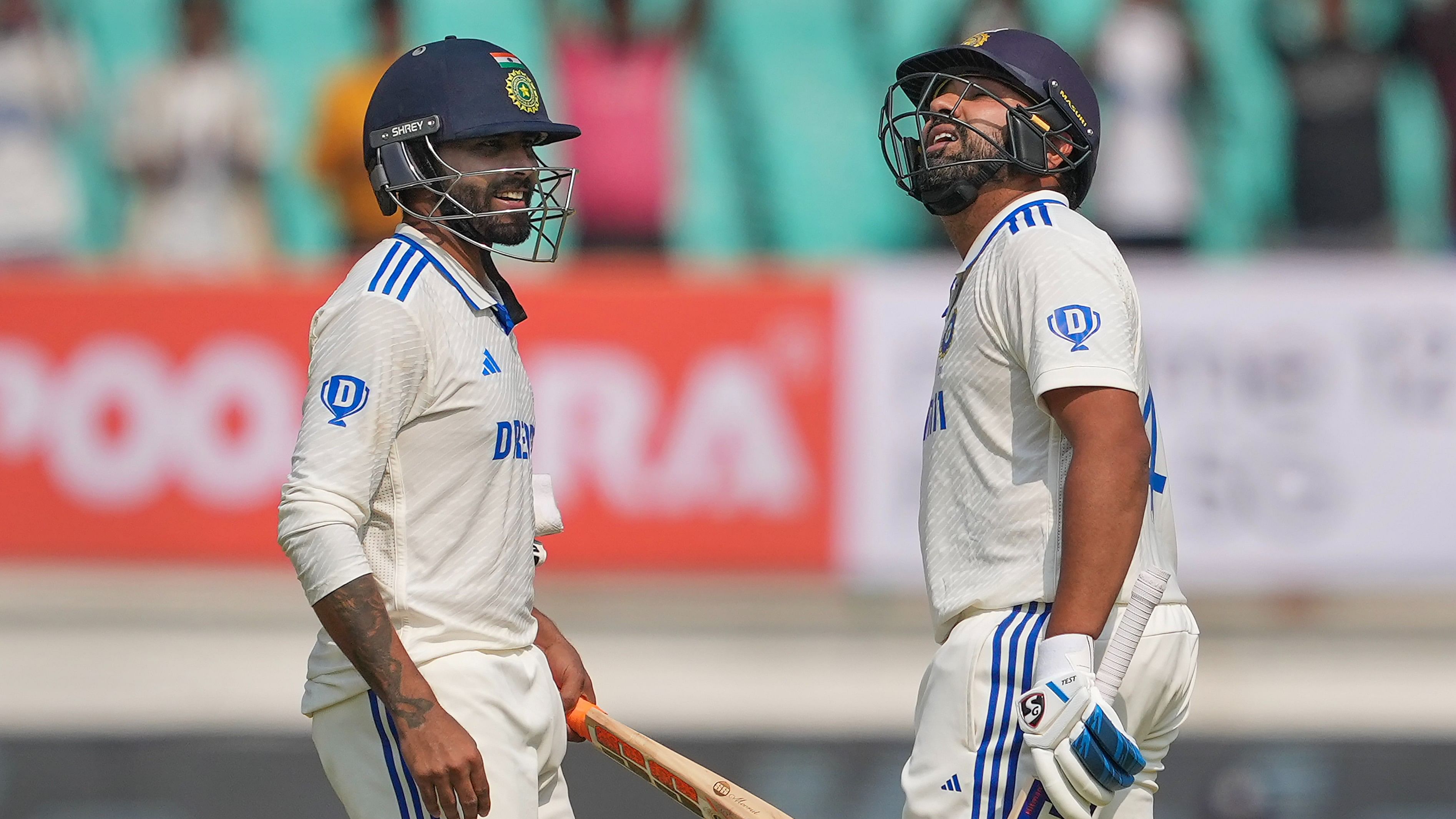 <div class="paragraphs"><p>India's captain Rohit Sharma celebrates his century with teammate Ravindra Jadeja on the first day of the third cricket test match between India and England, at Niranjan Shah Stadium, in Rajkot, on Thursday.</p></div>