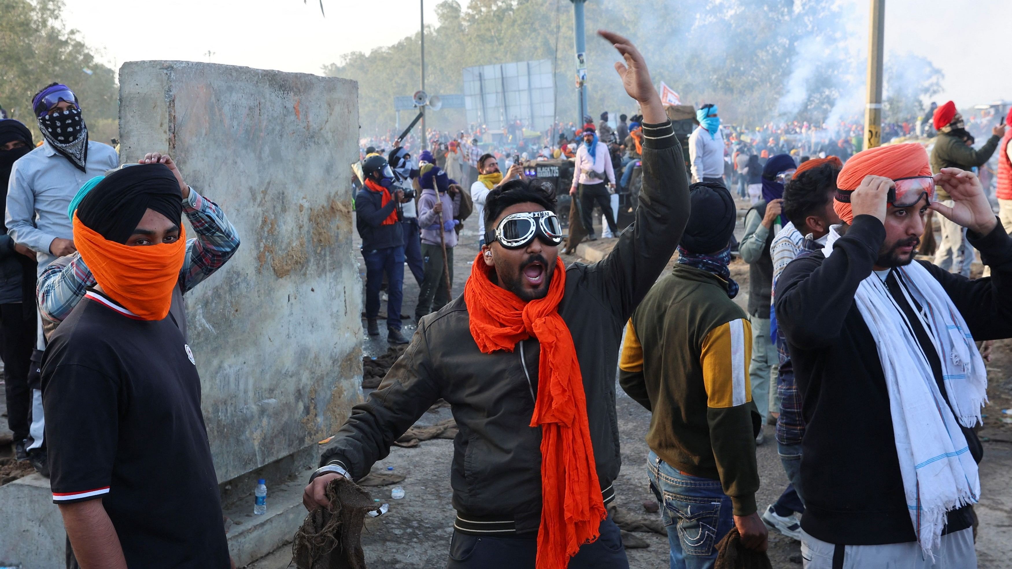 <div class="paragraphs"><p>A man gestures, as farmers march towards New Delhi to press for better crop prices promised to them in 2021, next to Shambhu barrier, a border crossing between Punjab and Haryana February 21, 2024.  </p></div>