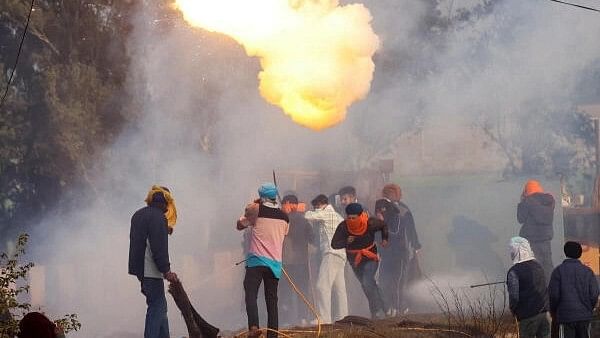 <div class="paragraphs"><p>Farmers, marching towards New Delhi to press for better crop prices promised to them in 2021, run for cover as tear gas is fired by police to disperse them, at Shambhu, a border crossing between Punjab and Haryana states, India, February 14, 2024.</p></div>