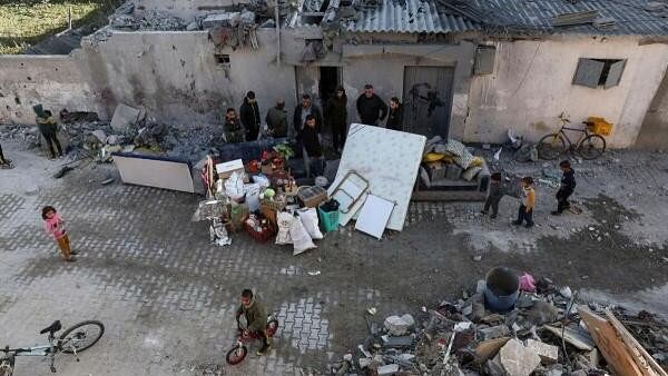 <div class="paragraphs"><p>Palestinians gather at the site of an Israeli strike on a house, amid the ongoing conflict between Israel and Hamas, in Rafah, in the southern Gaza Strip on February 21, 2024.</p></div>