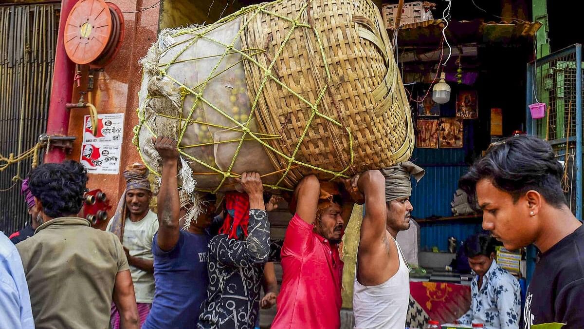 <div class="paragraphs"><p>Labourers carry a sack of vegetables at a wholesale market. Image for representation only.</p></div>