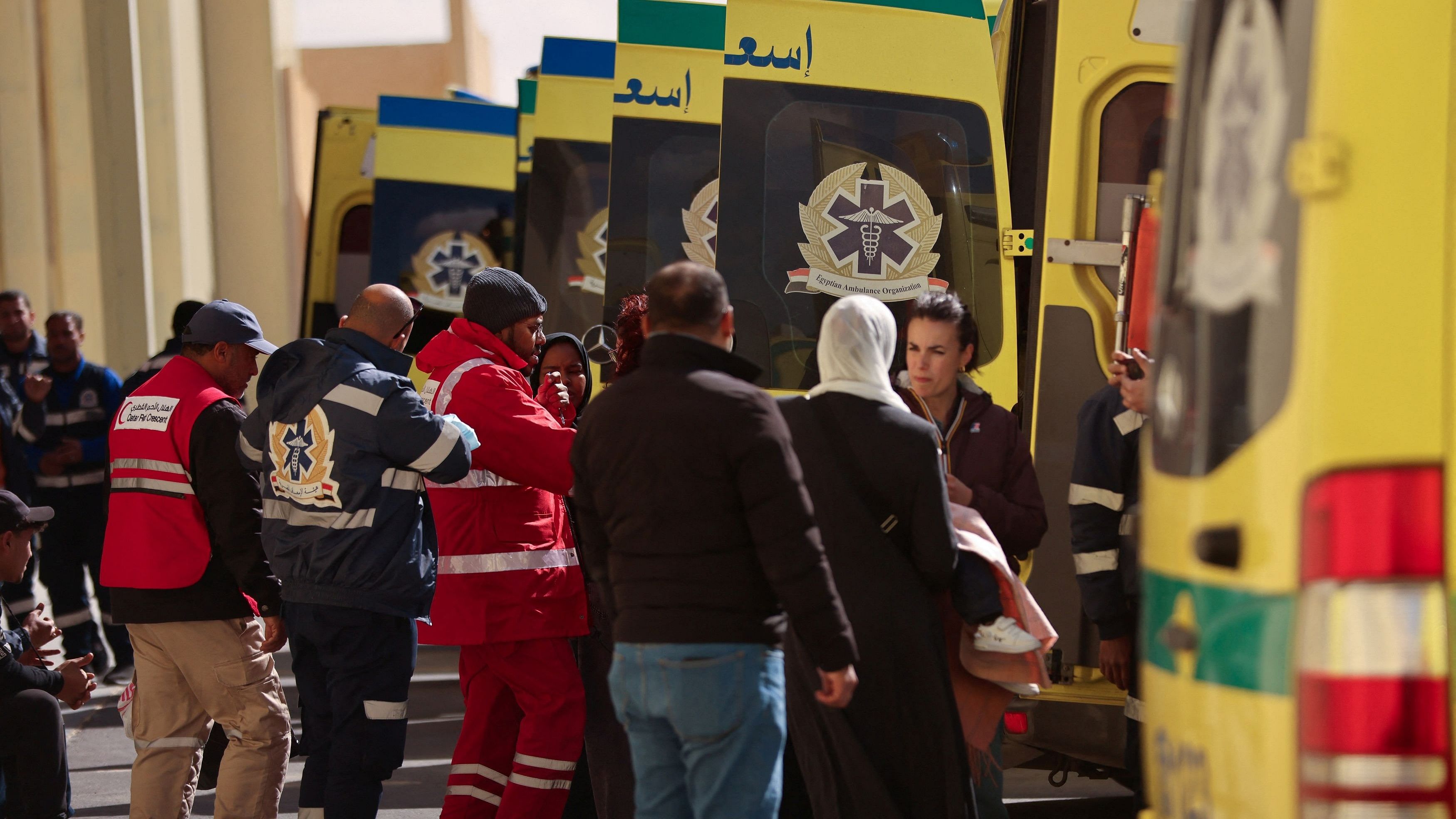 <div class="paragraphs"><p>Members of the Red Crescent and medical personnel stand near ambulances as injured Palestinians are evacuated via a Qatari aid plane for treatment in Qatar, amid the ongoing conflict between Israel and Palestinian Islamist group Hamas, at Al Arish Airport, Egypt, February 1, 2024. </p></div>