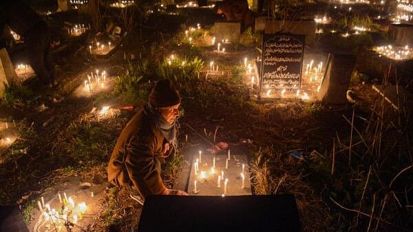 <div class="paragraphs"><p>People light candles while offering special prayers at the graves of their relatives on the occasion of Shab-e-Barat in Srinagar on Sunday night, </p></div>
