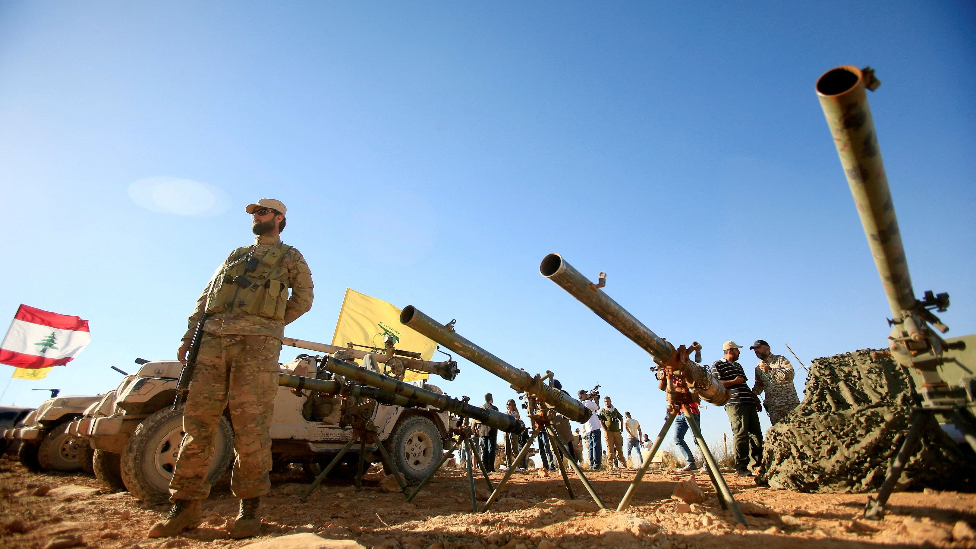 <div class="paragraphs"><p>A Hezbollah fighter stands in front of anti-tank artillery at Juroud Arsal.</p></div>