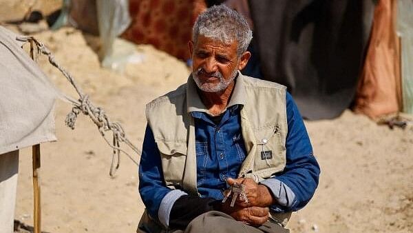 <div class="paragraphs"><p>Mohammed Al-Majdalawi, a displaced Palestinian man whose house was destroyed by Israeli strikes amid the ongoing conflict between Israel and Hamas, holds up the keys of his destroyed house, outside his tent in Rafah, in the southern Gaza Strip, February 26, 2024.</p></div>