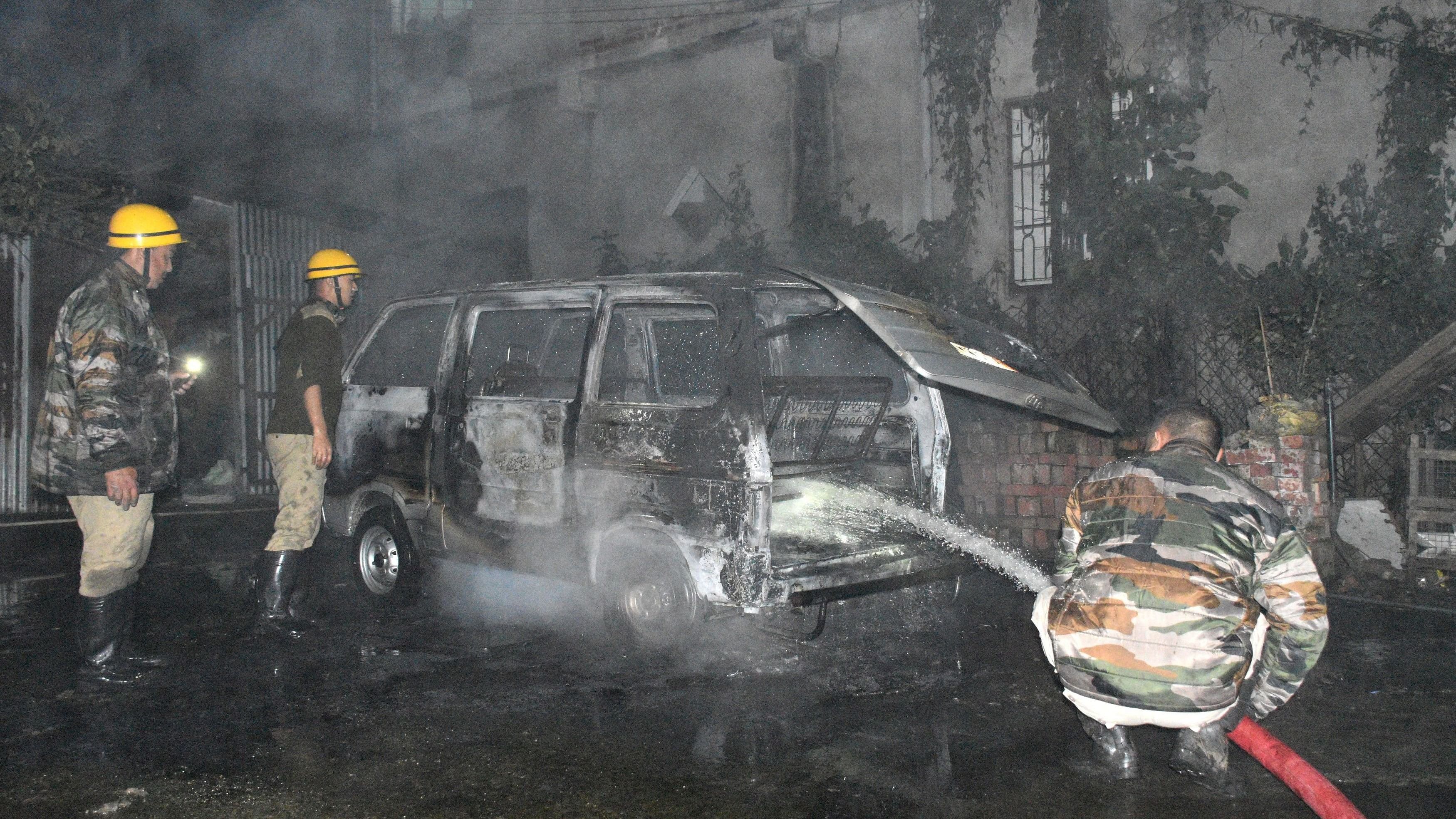 <div class="paragraphs"><p>Firefighters douse a vehicle after it was set on fire by unidentified men following a bomb blast inside the office premises of the All Manipur Students' Union in Imphal, Manipur, India, February 23, 2024. </p></div>