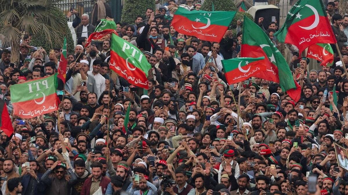 <div class="paragraphs"><p>Supporters of former Prime Minister Imran Khan's party, the Pakistan Tehreek-e-Insaf (PTI), wave flags as they protest demanding free and fair results of the elections</p></div>