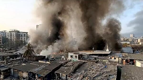 <div class="paragraphs"><p>Smoke billows after a fire broke out in a slum, at Bhayandar in Thane district, Wednesday, Feb. 28, 2024.</p></div>