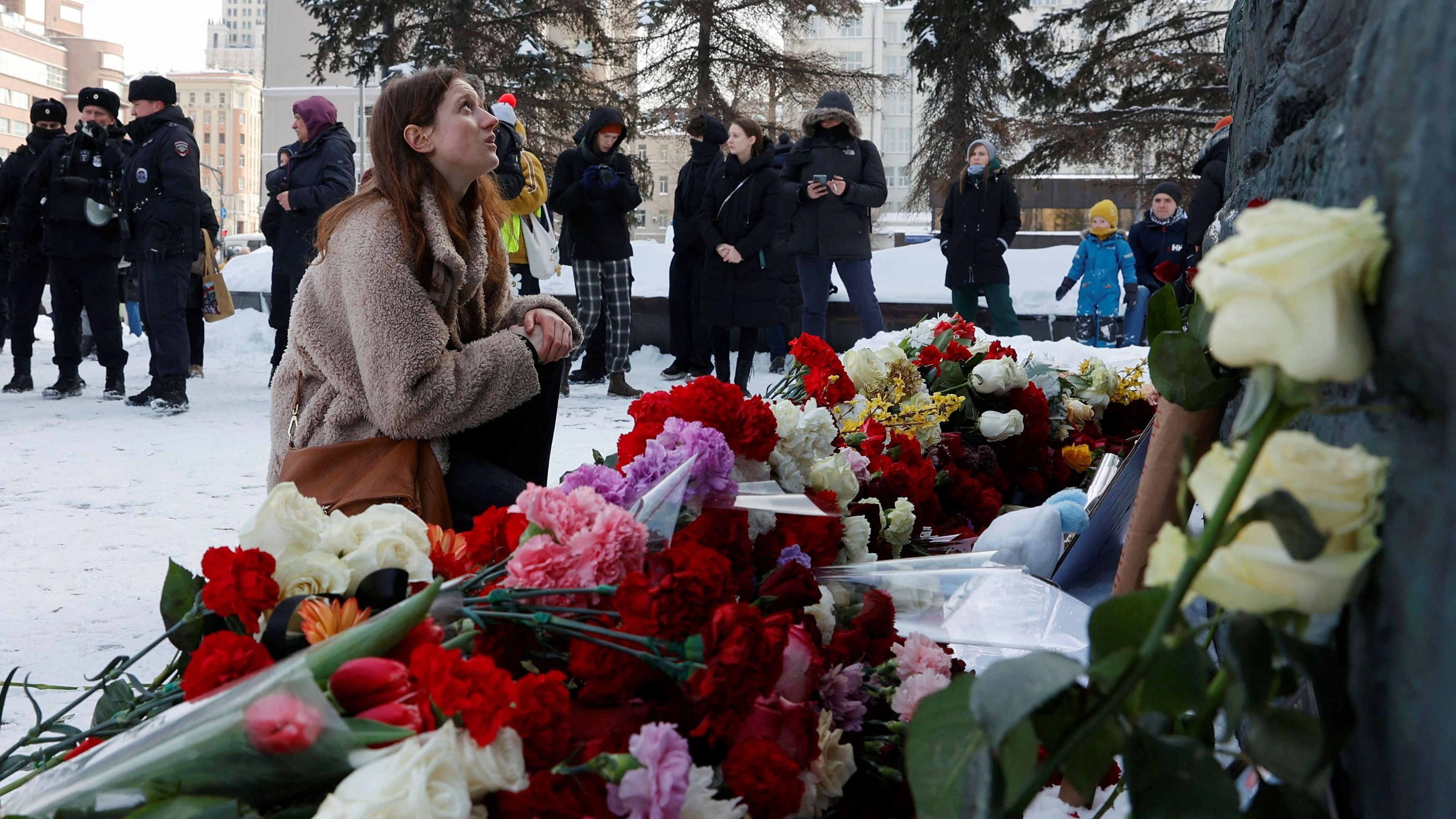 <div class="paragraphs"><p>A woman sits by the Wall of Grief monument to the victims of political repressions, where people gather to honour the memory of Russian opposition leader Alexei Navalny in Moscow, Russia, February 17, 2024. </p></div>