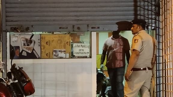 <div class="paragraphs"><p>Police personnel outside the store on Kumbarpet Main Road, where two senior citizens were fatally stabbed on Wednesday night, Feb 7, 2024.</p></div>