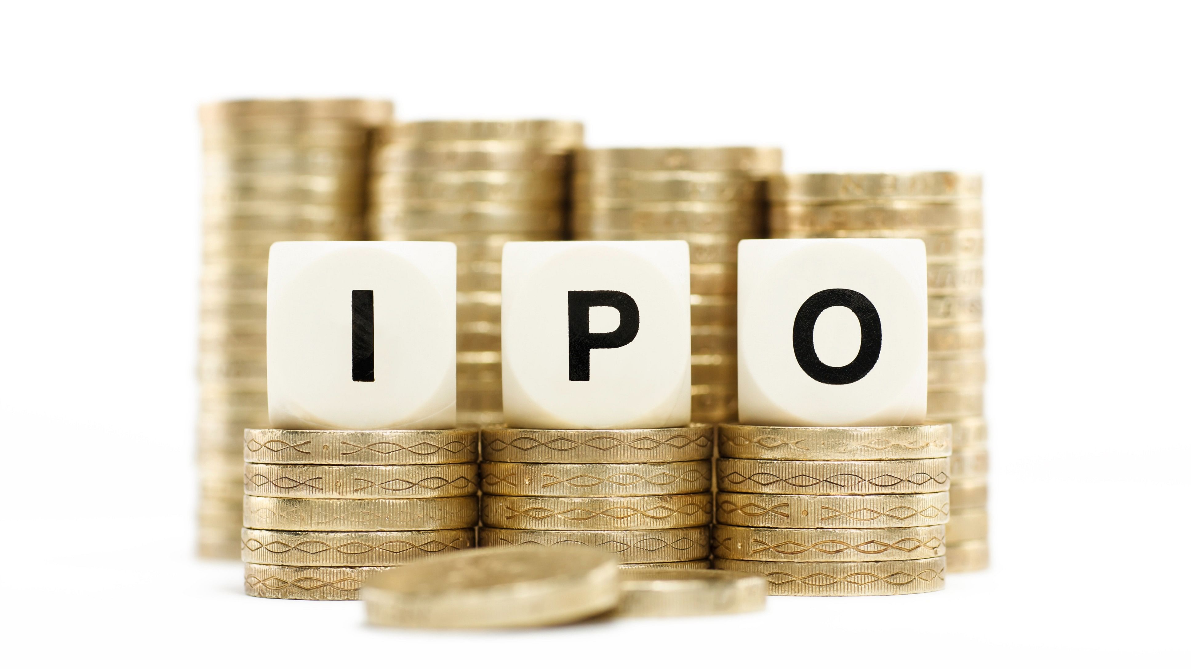 The letters IPO (Initial Public Offering) on dice letters on stacks of gold coins isolated on a white background.
IPO