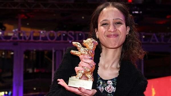 <div class="paragraphs"><p>Director Mati Diop poses with the Golden Bear for Best Film for 'Dahomey', after the award ceremony of the 74th Berlinale International Film Festival in Berlin, Germany.</p></div>