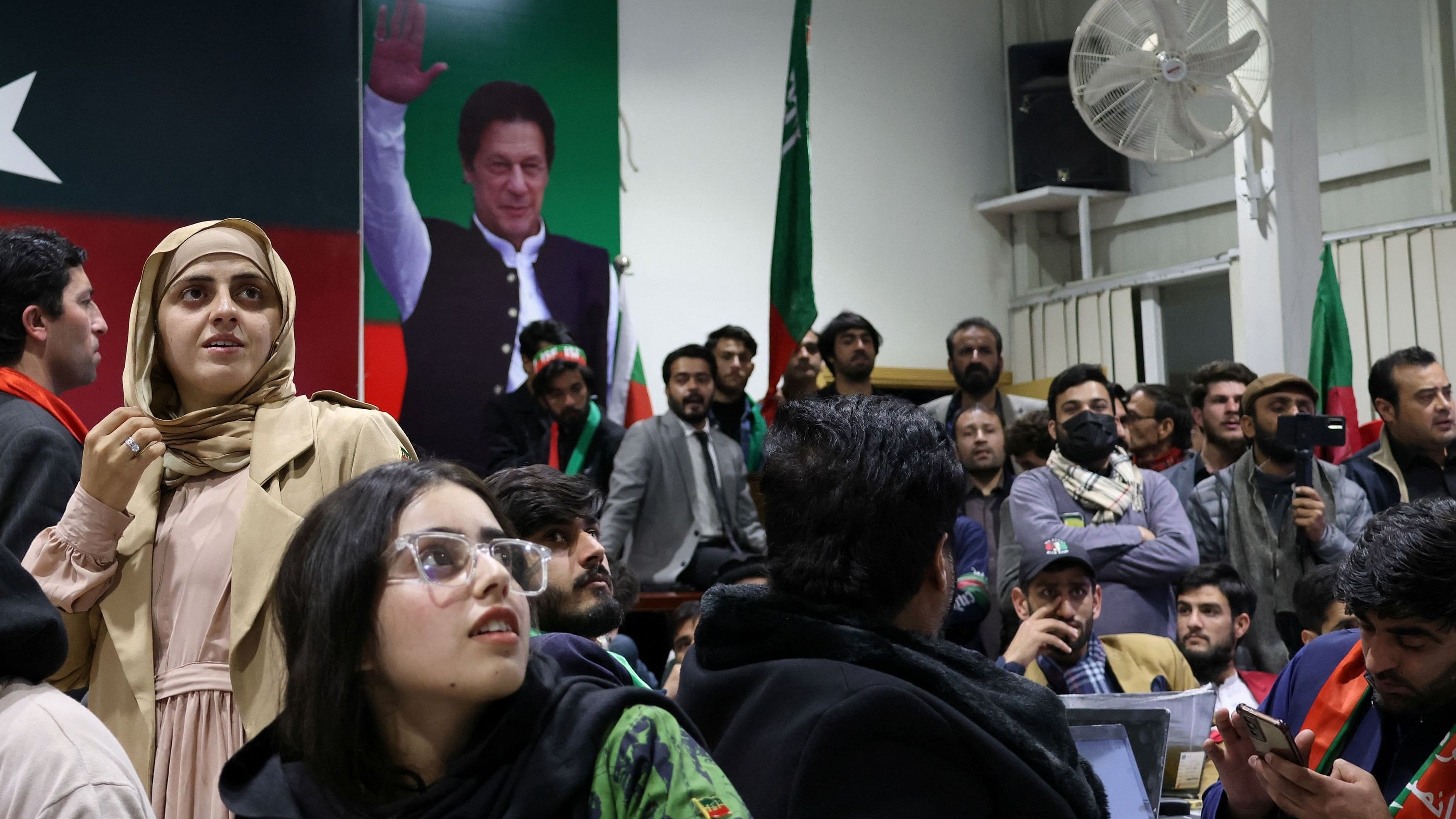 <div class="paragraphs"><p>Volunteers for former Prime Minister Imran Khan's party Pakistan Tehreek-e-Insaf  look on as they watch results on TV screens after the end of the polling  at the party's main office in Islamabad, Pakistan, February 8, 2024. </p></div>