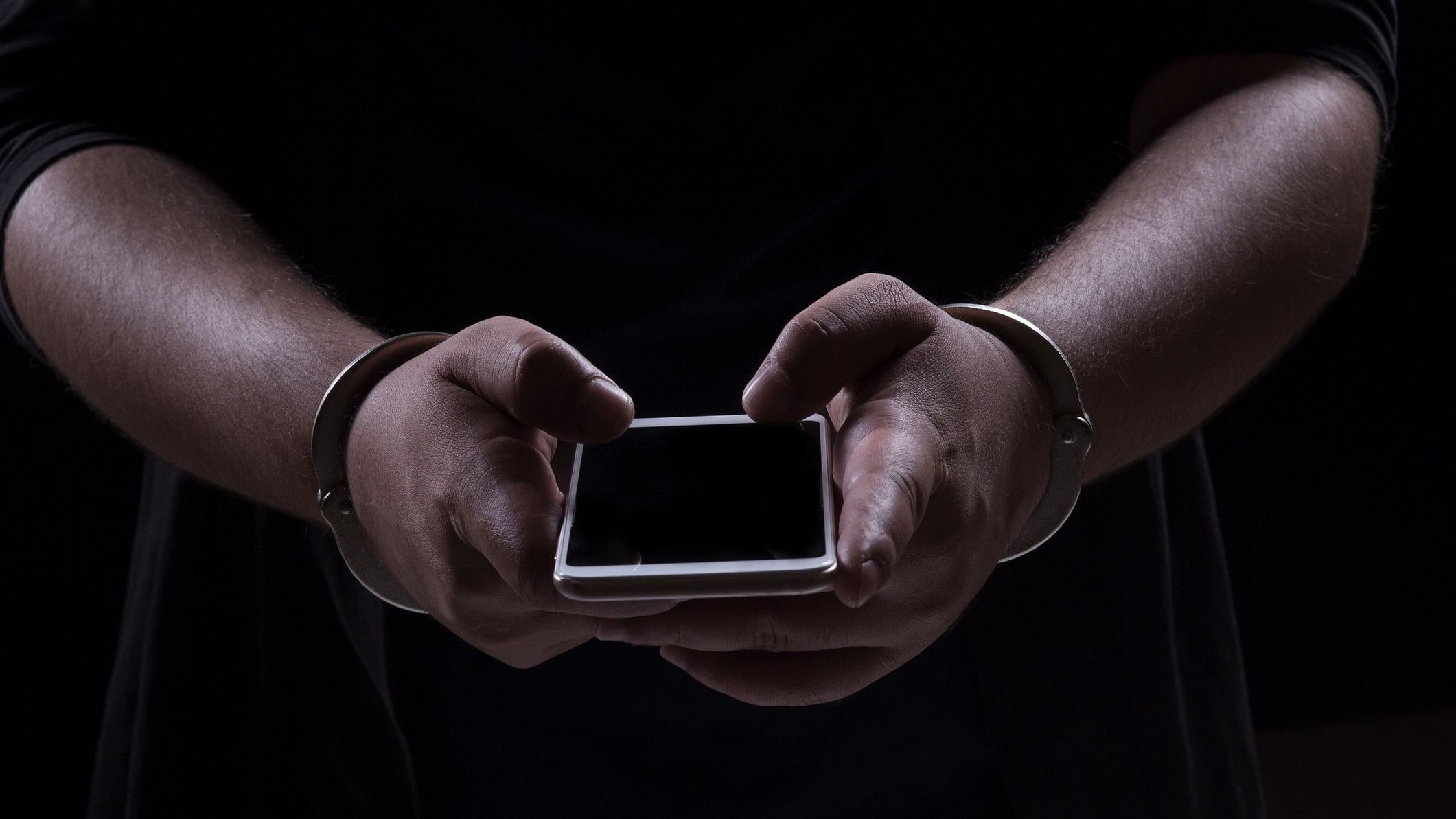 <div class="paragraphs"><p>Representative image showing a man in cuffs with a phone in his hand.</p></div>