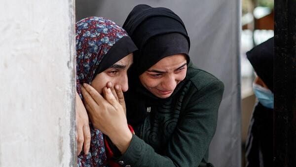 <div class="paragraphs"><p>Mourners react following the death of Palestinians in Israeli strikes, in Rafah.</p></div>
