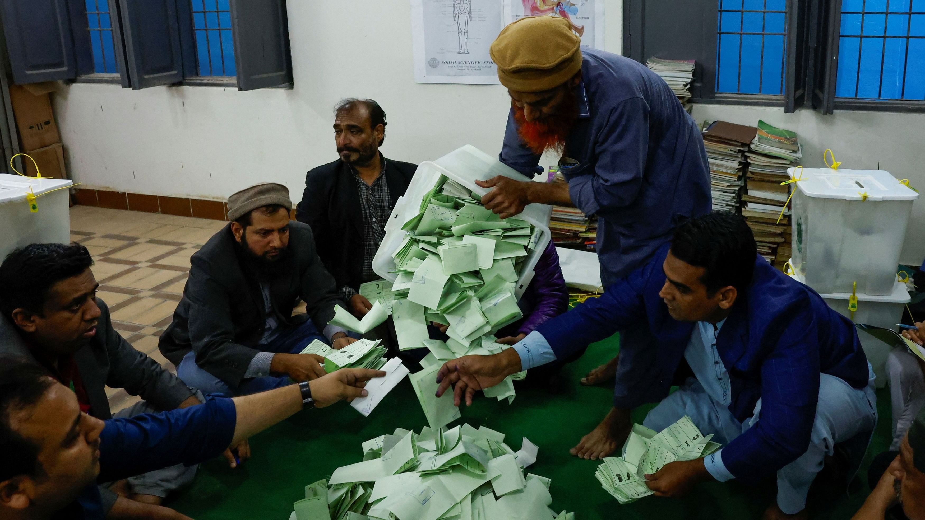 <div class="paragraphs"><p>Polling officers count ballot papers during the general election in Karachi, Pakistan.</p></div>