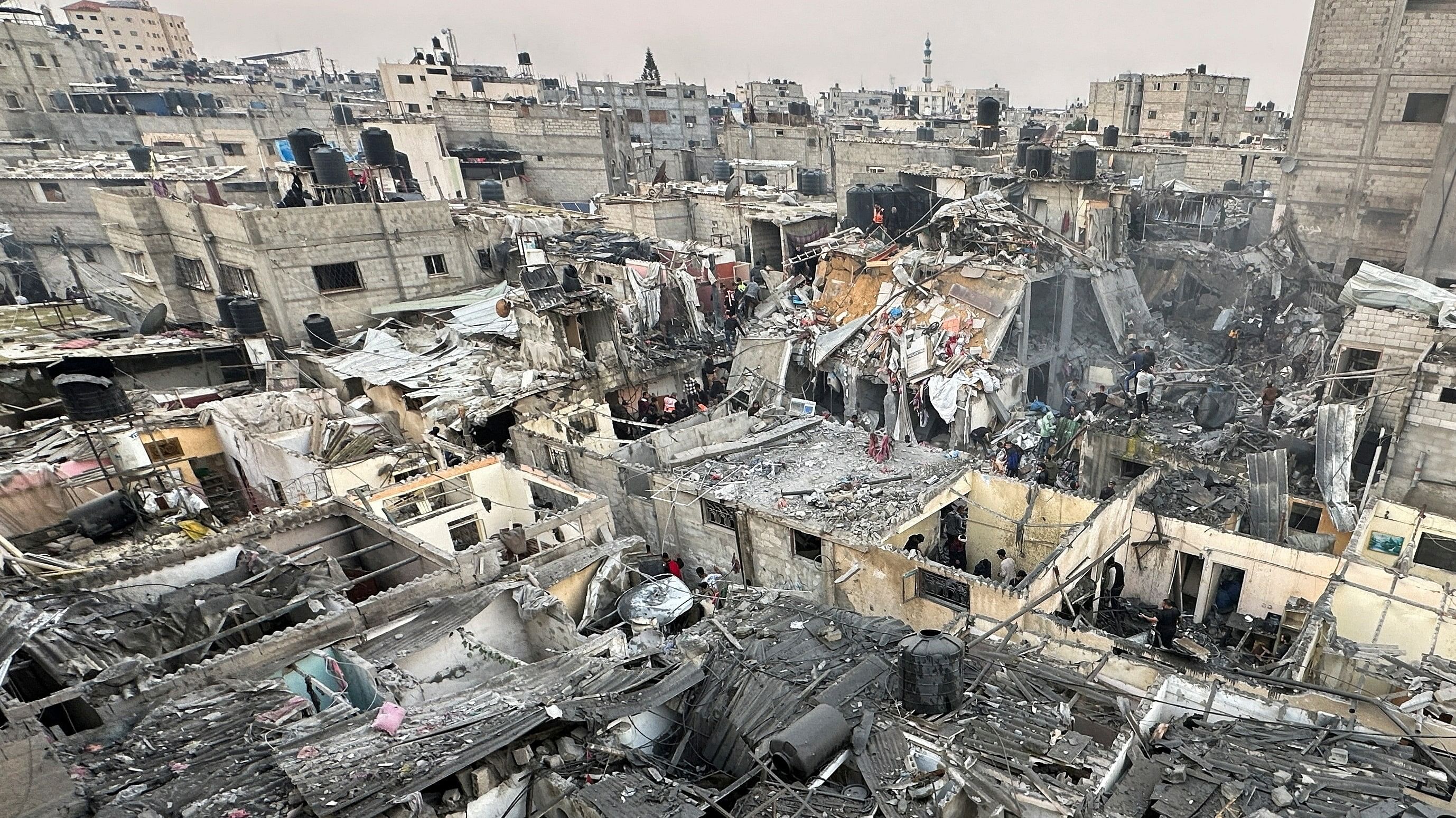 <div class="paragraphs"><p> People search through the rubble of damaged buildings following an Israeli air strike on Palestinian houses, amid the ongoing conflict between Israel and the Palestinian Islamist group Hamas, in Rafah in the southern Gaza Strip December 12, 2023. </p></div>