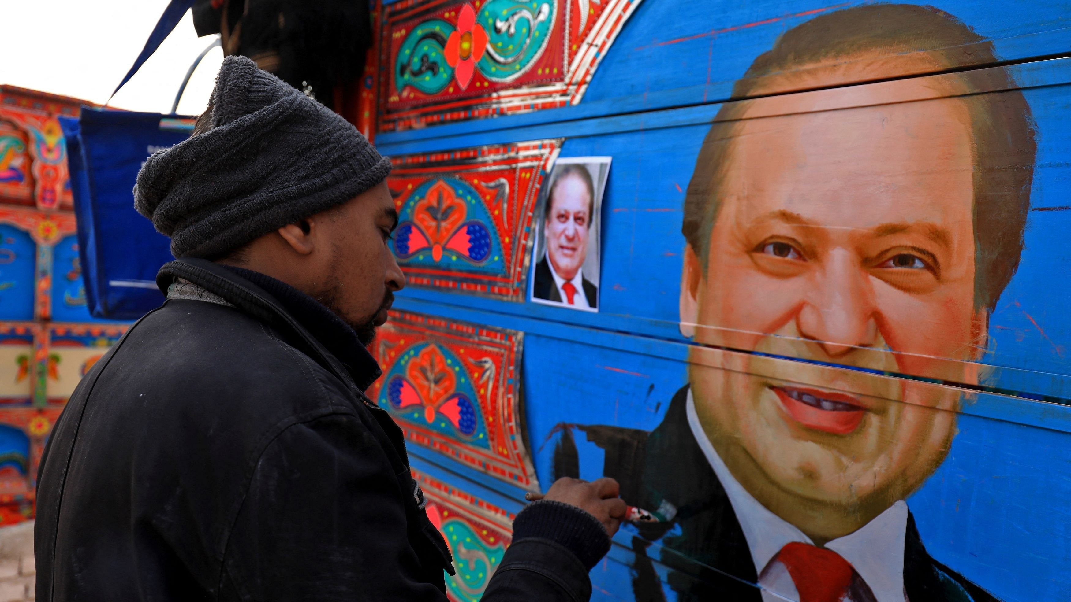 <div class="paragraphs"><p>A truck art painter, applies the final touches to a portrait of Nawaz Sharif in Pakistan. </p></div>