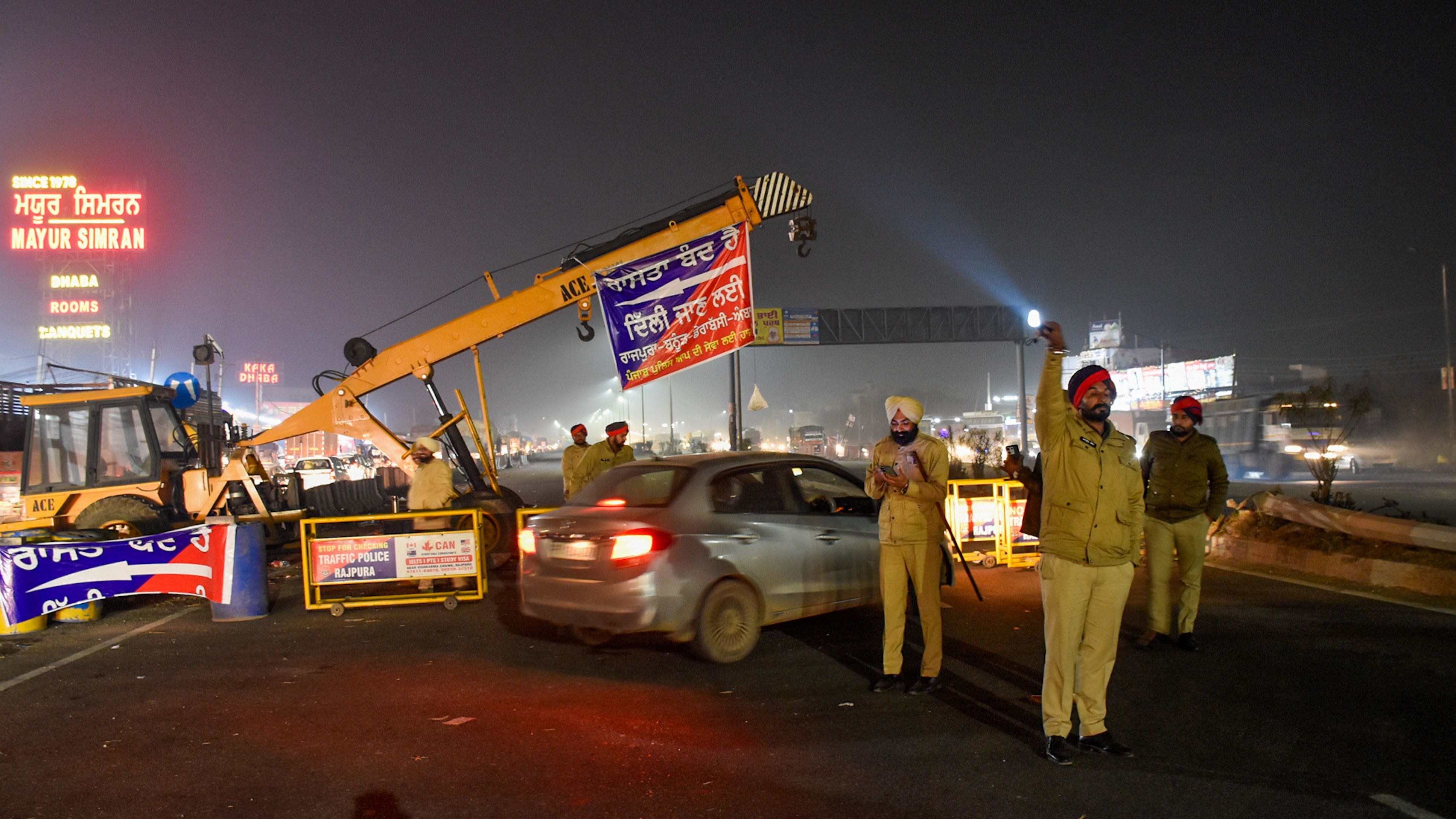 <div class="paragraphs"><p>Police personnel stand guard during traffic restrictions near Shambhu Border ahead of the scheduled march by the protesting farmers towards Delhi.</p></div>