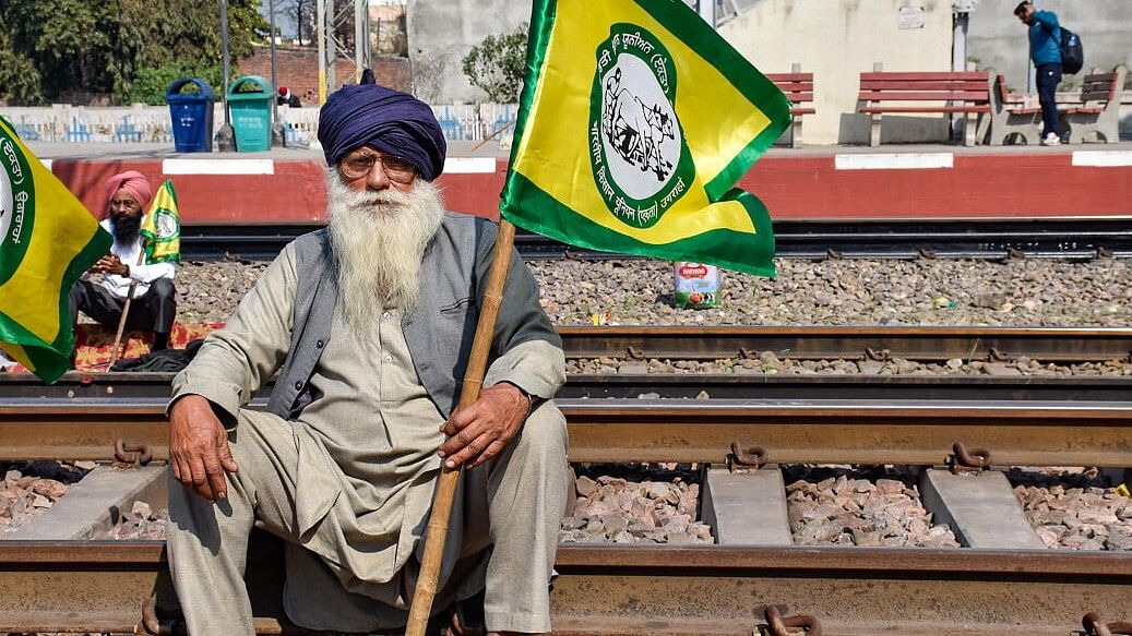 <div class="paragraphs"><p>Bharatiya Kisan Union members block railway tracks at Rajpura as they stage 'rail roko' protest in support of farmers agitating at Punjab-Haryana Shambhu border, in Patiala.</p></div>