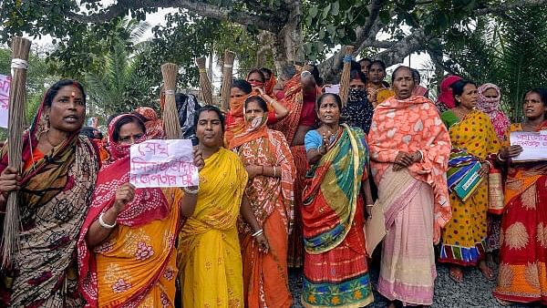 <div class="paragraphs"><p>Women holding posters stage a protest demanding the arrest of local TMC leaders over Sandeshkhali incident allegations, in North 24 Parganas district, Sunday, Feb. 25, 2024.</p></div>