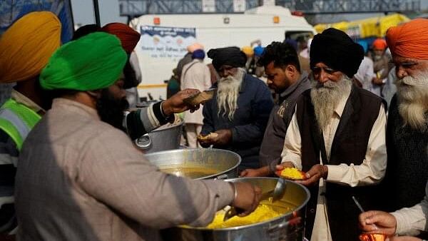 <div class="paragraphs"><p>Volunteers serve food to other farmer members at Shambhu Barrier, a border crossing between Punjab and Haryana states, India on February 20, 2024.</p></div>