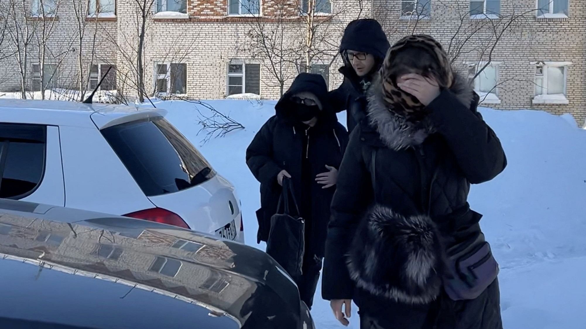 <div class="paragraphs"><p>A woman  wearing a protective mask and sunglasses, believed to be Lyudmila Navalnaya, the mother of Russian opposition leader Alexei Navalny, is accompanied into a car as she leaves the IK-3 penal colony, where her son served his jail term and where he died the day before, according to prison authorities, in the settlement of Kharp in the Yamal-Nenets Region, Russia February 17, 2024, in this still image taken from video. </p></div>