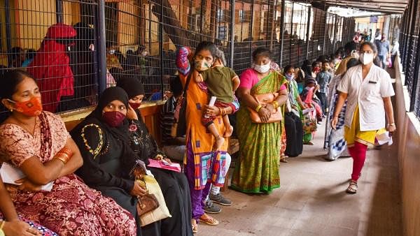 <div class="paragraphs"><p> Patients wait in a long queue at a government hospital.</p></div>