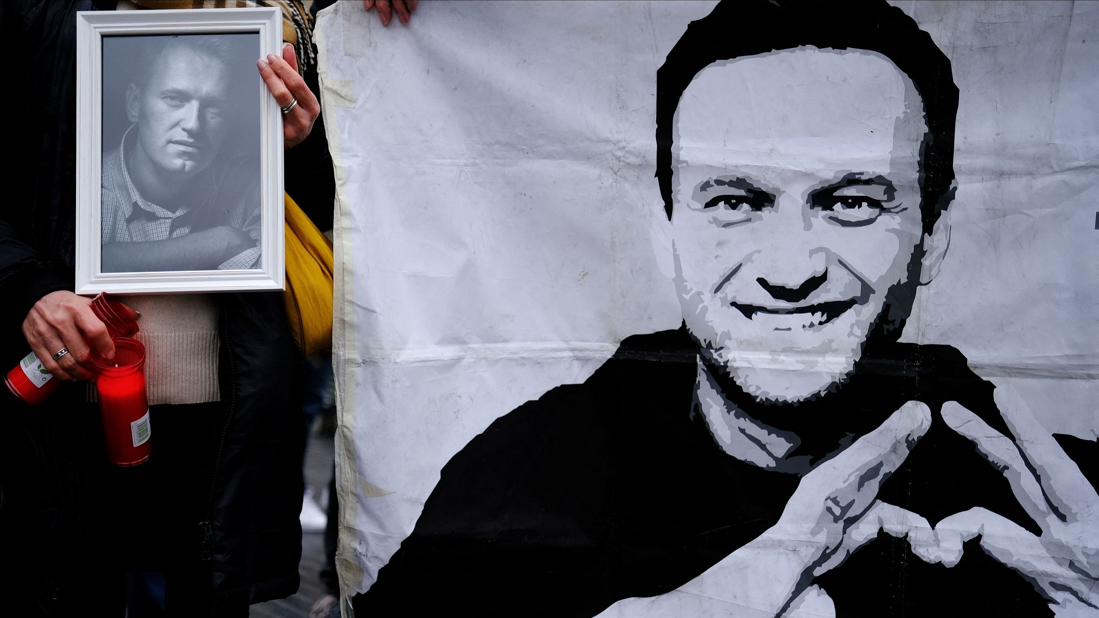 <div class="paragraphs"><p>A woman holds candles and a portrait of late Russian opposition leader Alexei Navalny, who died unexpectedly in prison ten days ago, in front of his memorial at Las Ramblas of Barcelona, as people attend a vigil after the body of him was handed to his mother on Saturday in the Arctic city of Salekhard, in Barcelona, Spain, February 25, 2024.</p></div>